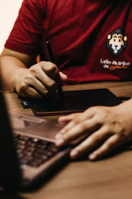 Close-up of hands interacting with a shopping website on a laptop screen indoors.